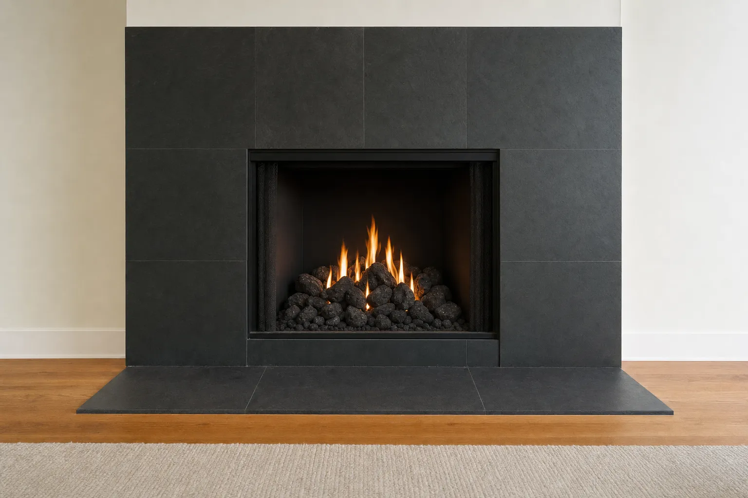 Design visualization, after: a fireplace with a dark slate surround with dark volcanic lava rock under a soft flame in a black firebox