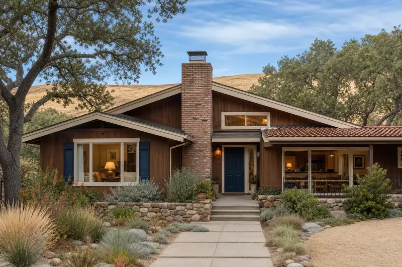 A 1970s wood-sided contemporary house with a used-brick chimney with a spark arrestor cap rising above the roof; illustrative image