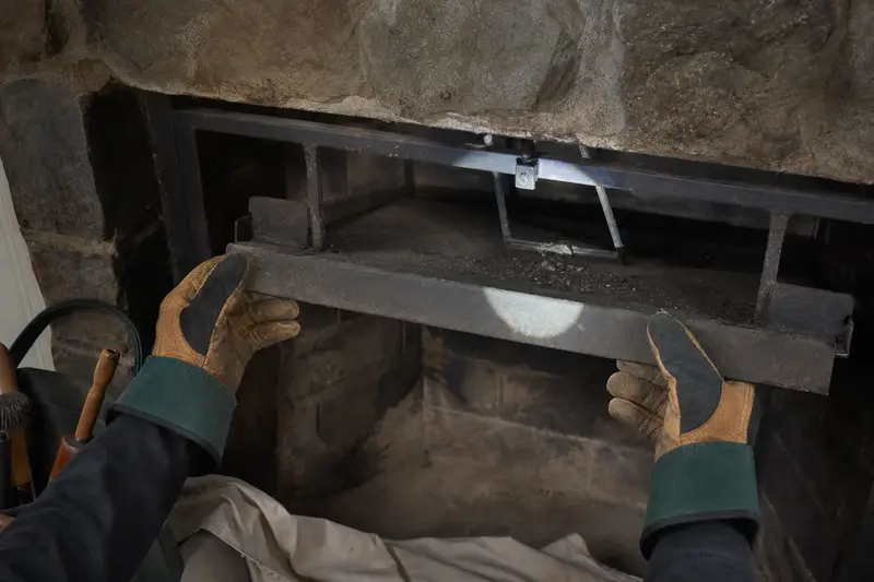 A smoke shelf and damper frame lit by a flashlight beam; illustrative image