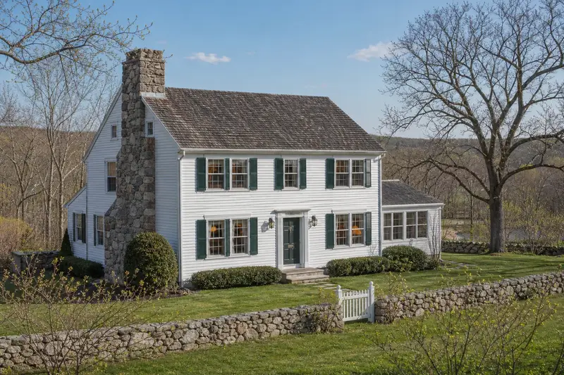 A 1950s colonial with a fieldstone chimney with a stone masonry chimney and neat, even mortar joints; illustrative image