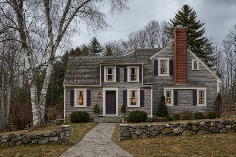 A 1940s saltbox house with a red brick chimney with a concrete crown and neat, even mortar joints; illustrative image