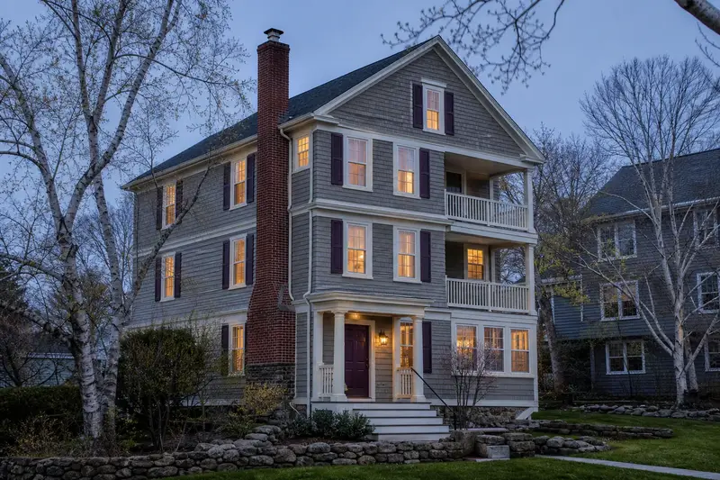 A 1950s triple-decker house with a red brick chimney with a concrete crown fitted with a stainless steel liner cap; illustrative image