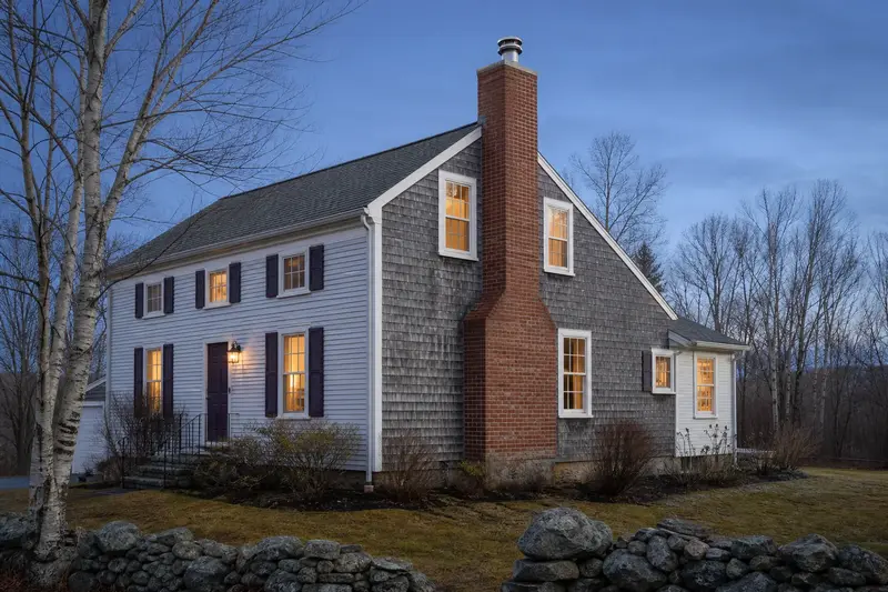 A 1950s saltbox house with a red brick chimney with a concrete crown fitted with a stainless steel liner cap; illustrative image