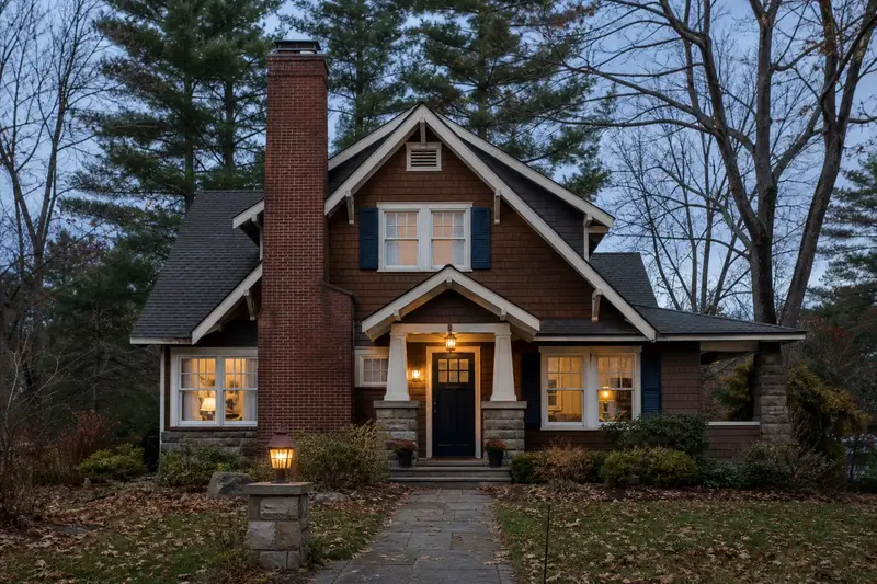 A 1940s Craftsman house seen from the street with a tall brick chimney on a steep gable roof; illustrative image