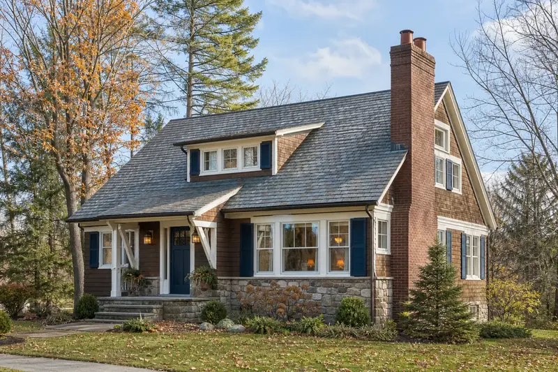 A 1950s Craftsman house with a two-flue brick chimney on a slate roof and neat mortar joints; illustrative image