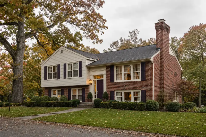 A 1980s split-level house with brick and siding with a brick chimney with corbelled top courses and neat mortar joints; illustrative image