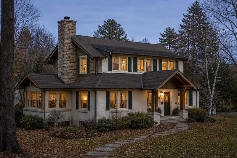 A 1950s Craftsman house in soft daylight with a stone masonry chimney standing clear above the roofline; illustrative image
