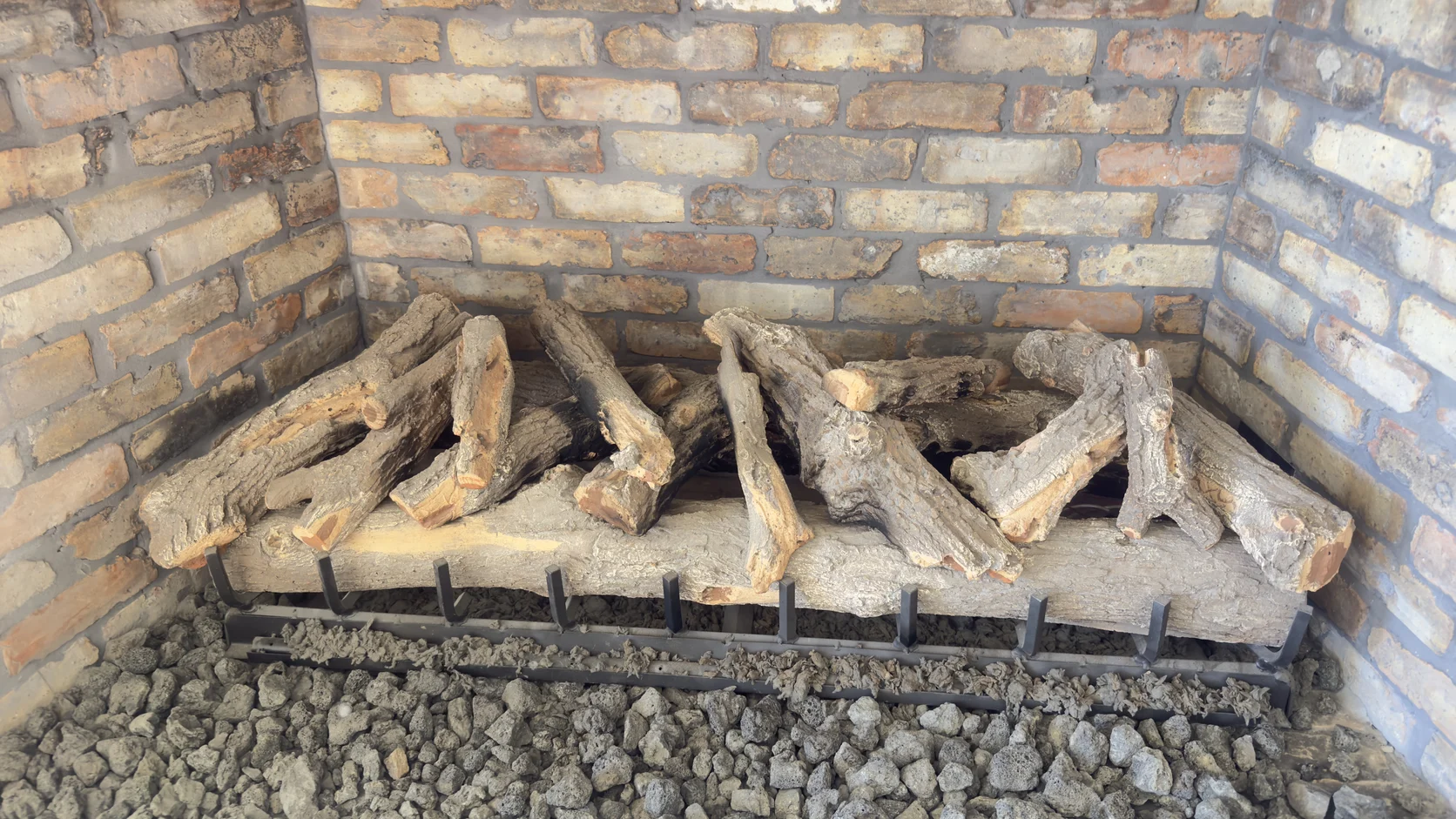 Gas log set in a red brick firebox