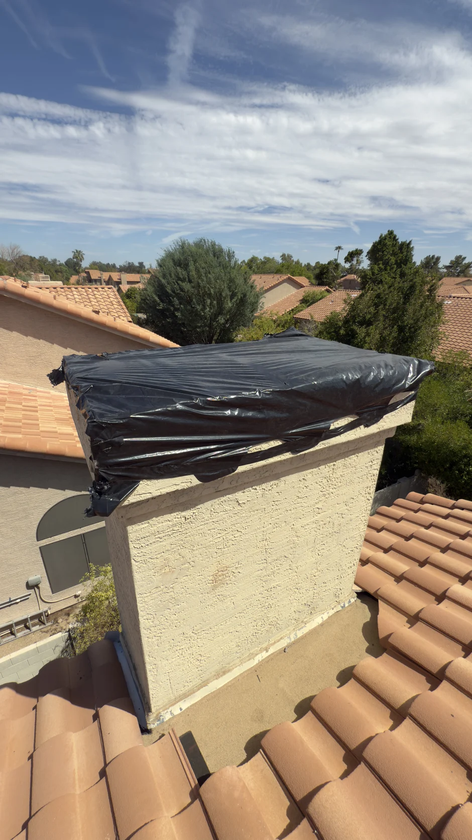 Chimney top covered with sheet plastic during the work