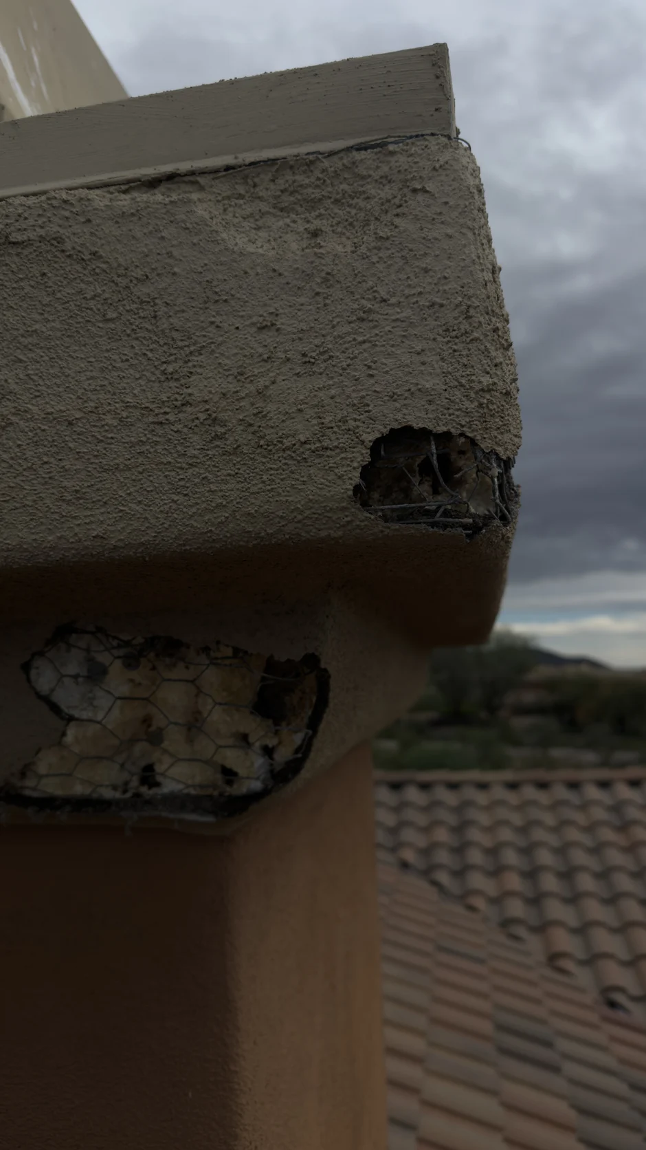 Underside of a chimney crown with loose debris