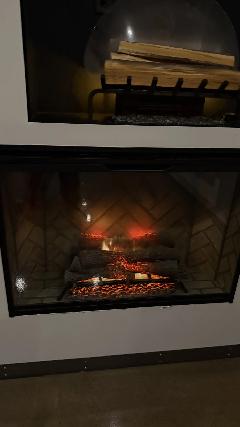 Lit fireplace insert in a dark metal frame