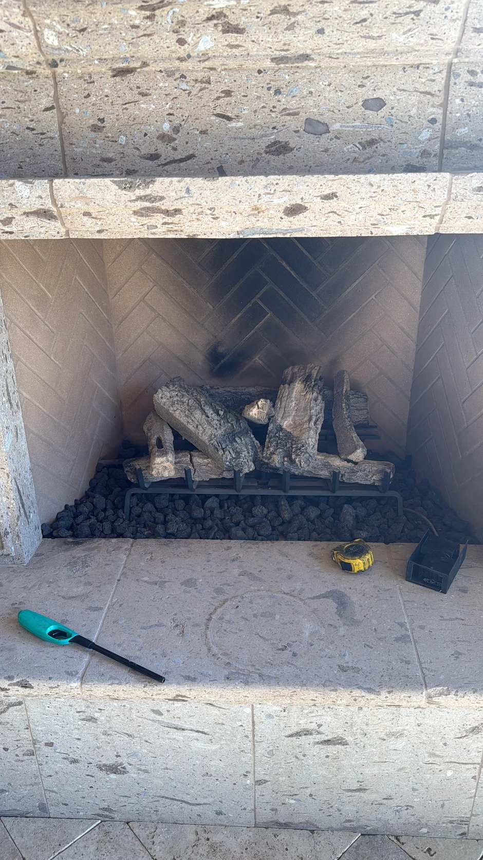 Gas log set inside a firebox above a tiled hearth
