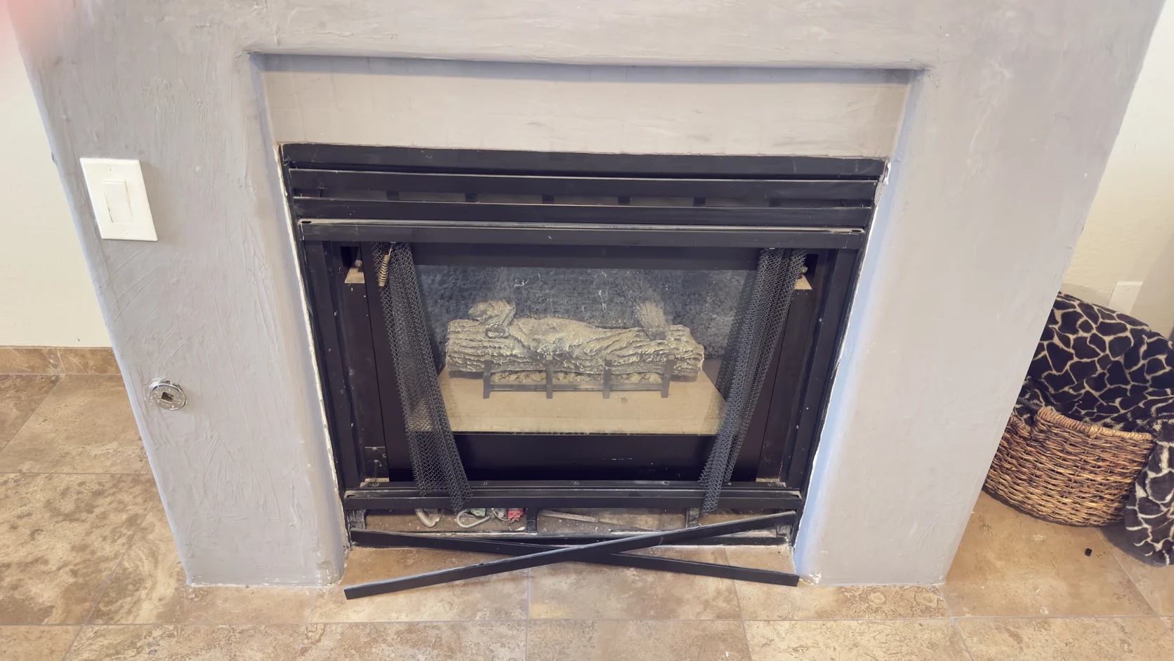 Log set in a firebox with a spirit level resting nearby