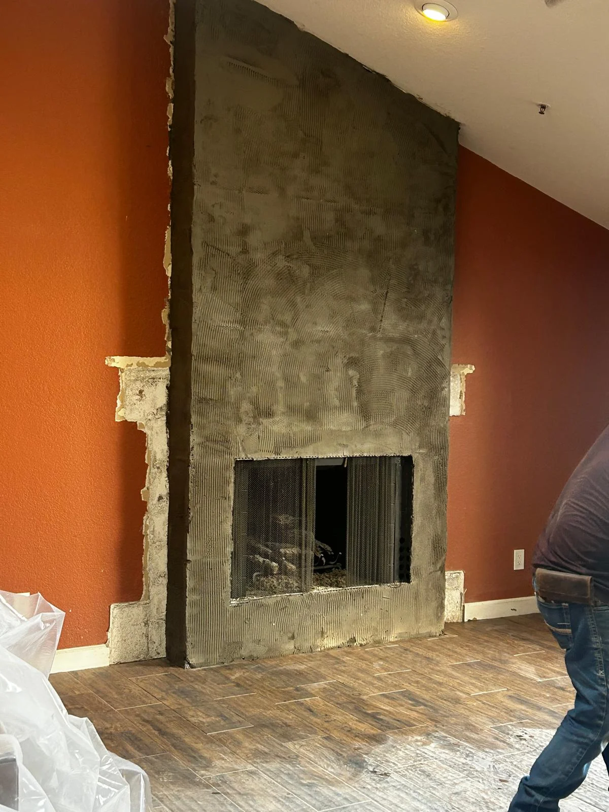 Partially demolished fireplace surround during a remodel