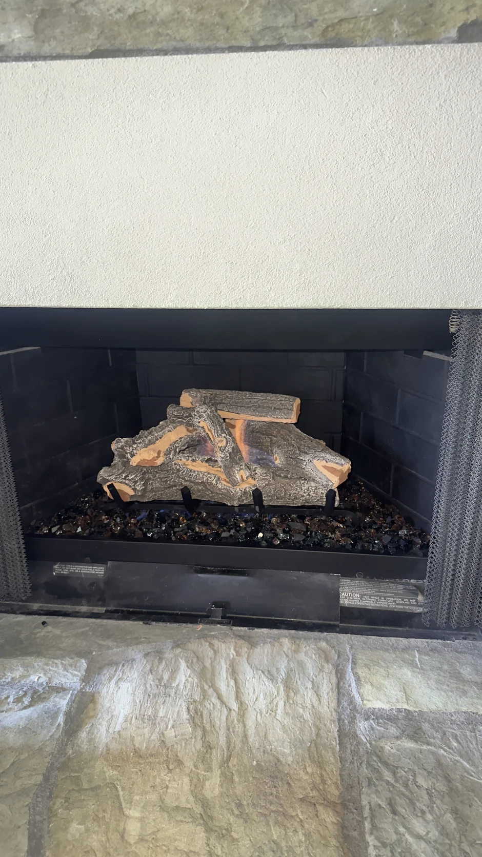 Fireplace with a log set in a plain surround