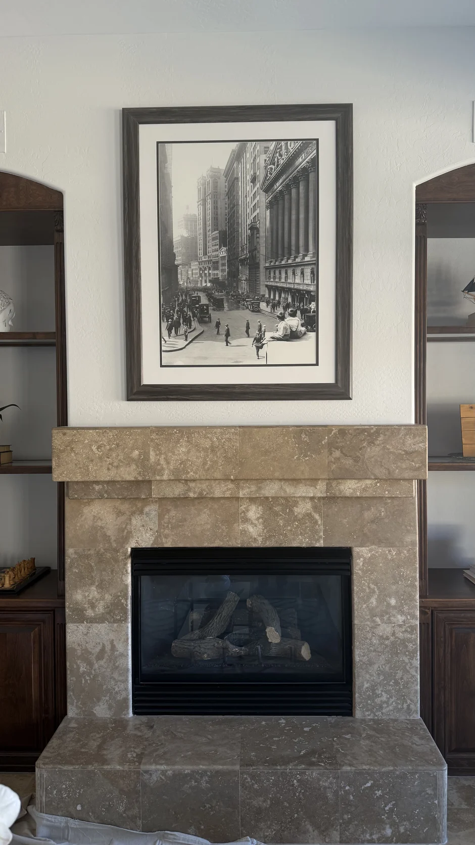 Fireplace with a framed print above the mantel