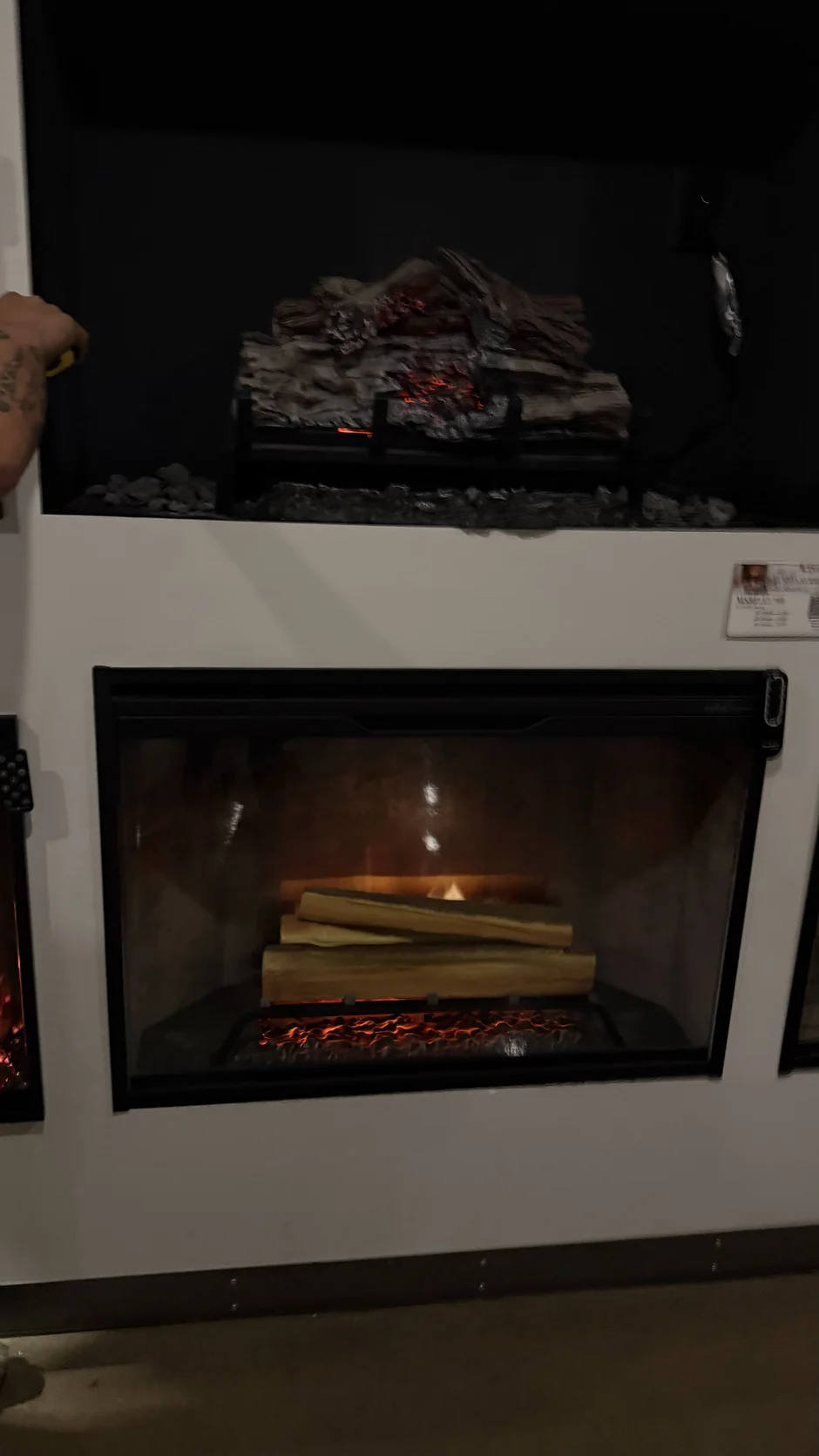 Close view of a fireplace insert with a log set