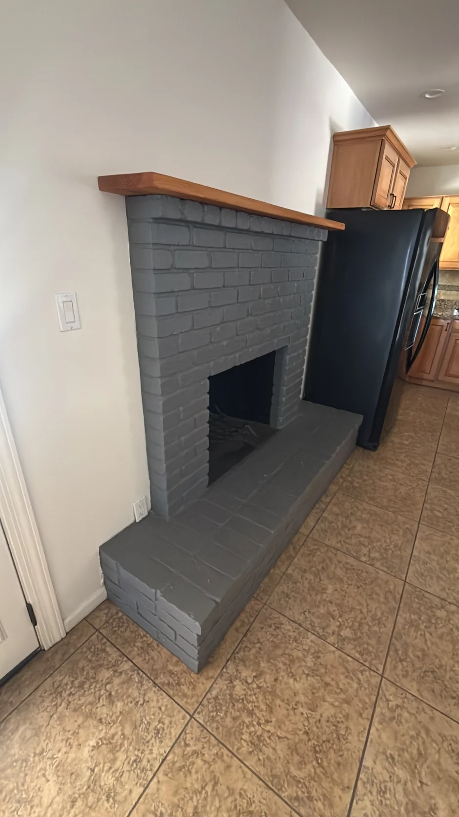 Painted brick fireplace and raised hearth in a living room