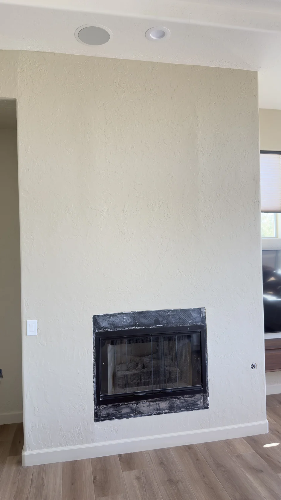 Small fireplace opening in a plain white wall