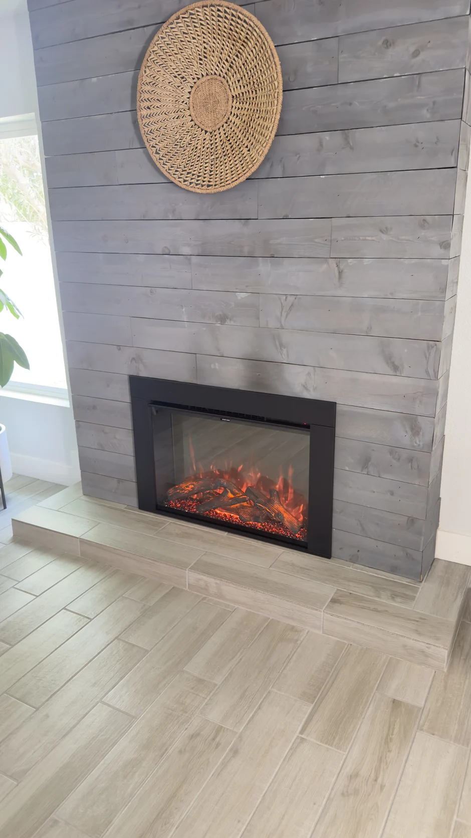 Fireplace insert in a grey shiplap wall