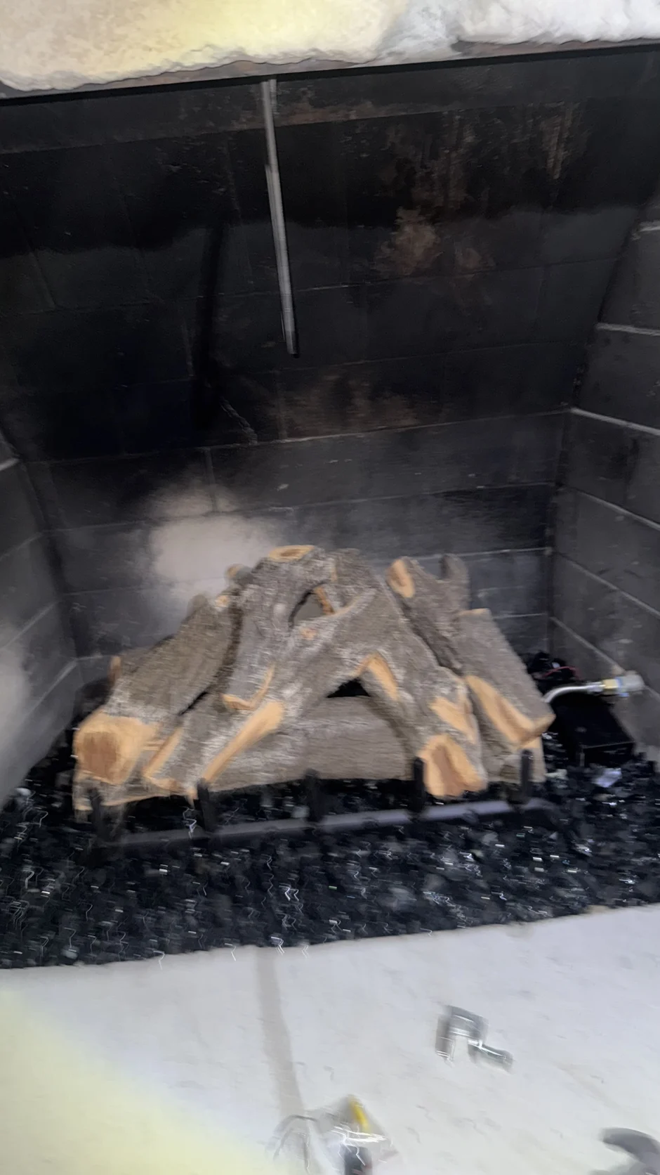 Soot-covered logs in a firebox
