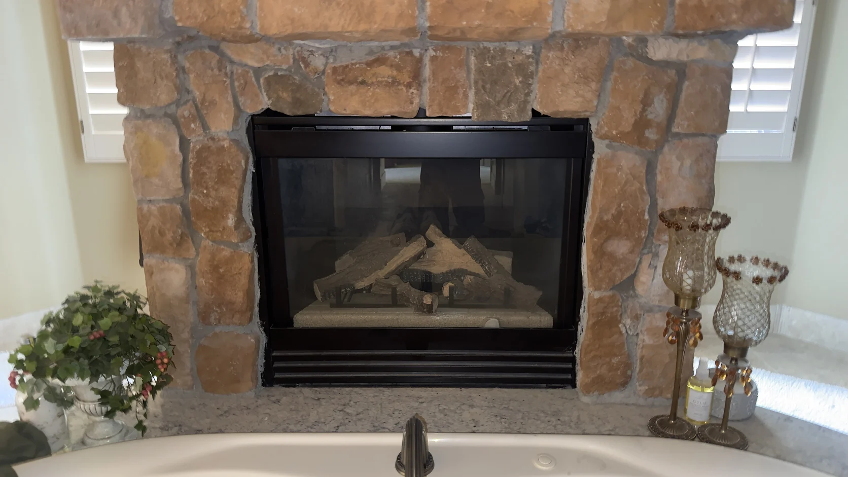 Stone fireplace with a decorated mantel