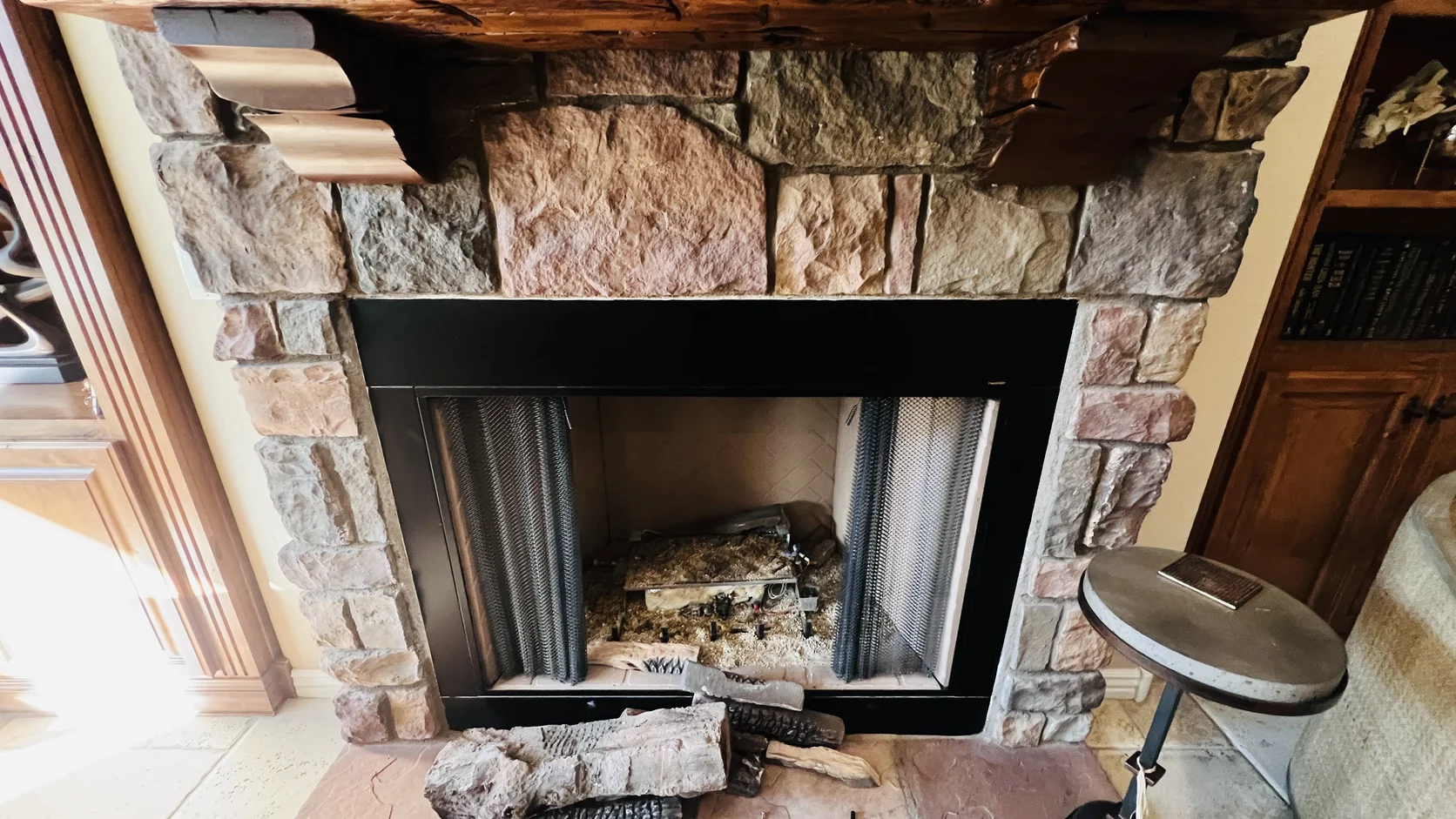 Dark firebox inside a rustic stone surround