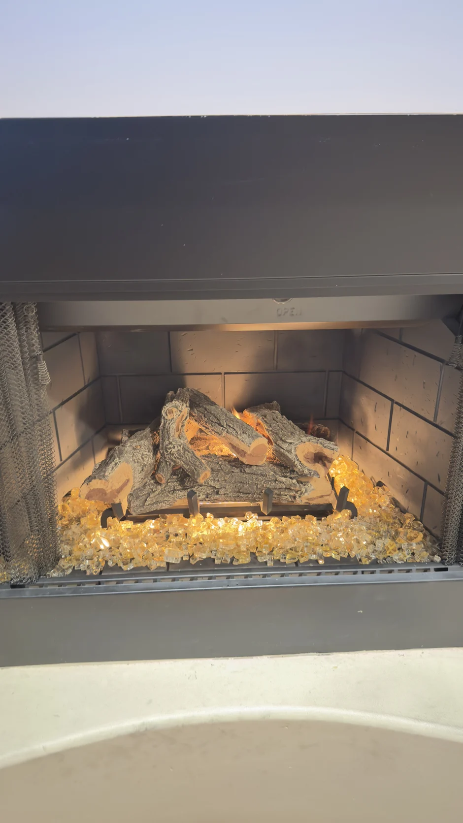 Gas fireplace set into a stone wall