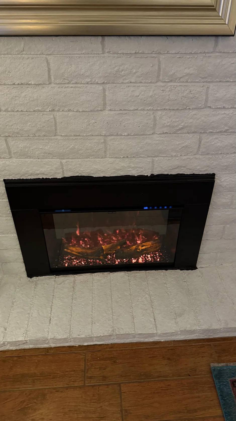 Fireplace insert in a white brick wall