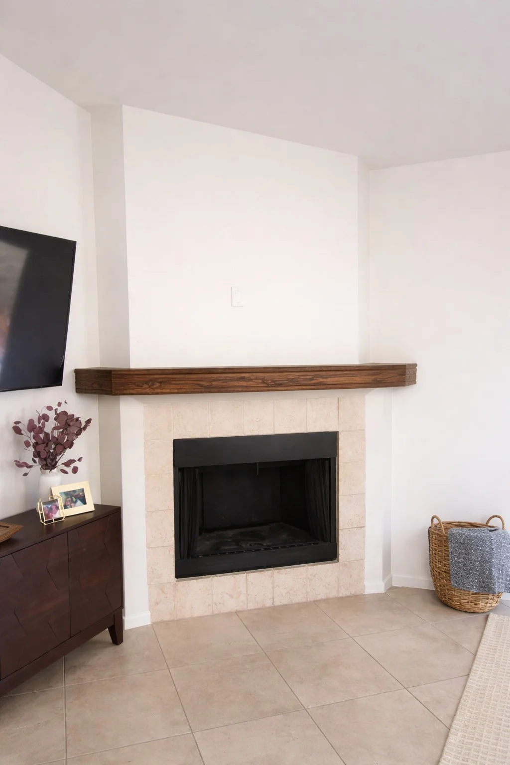 White plaster fireplace with a dark firebox